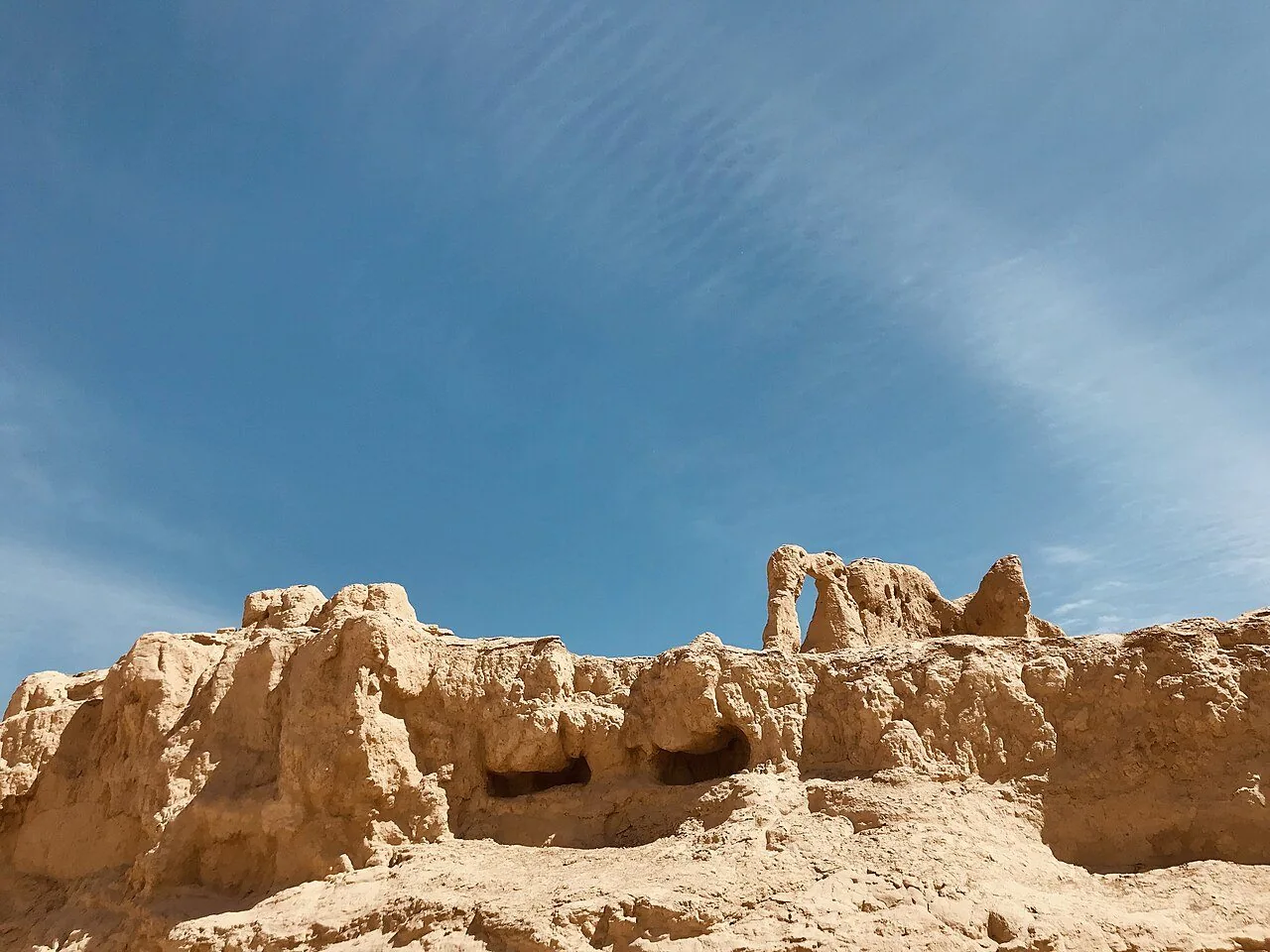 Earthen remains rising against the sky at Jiaohe.
