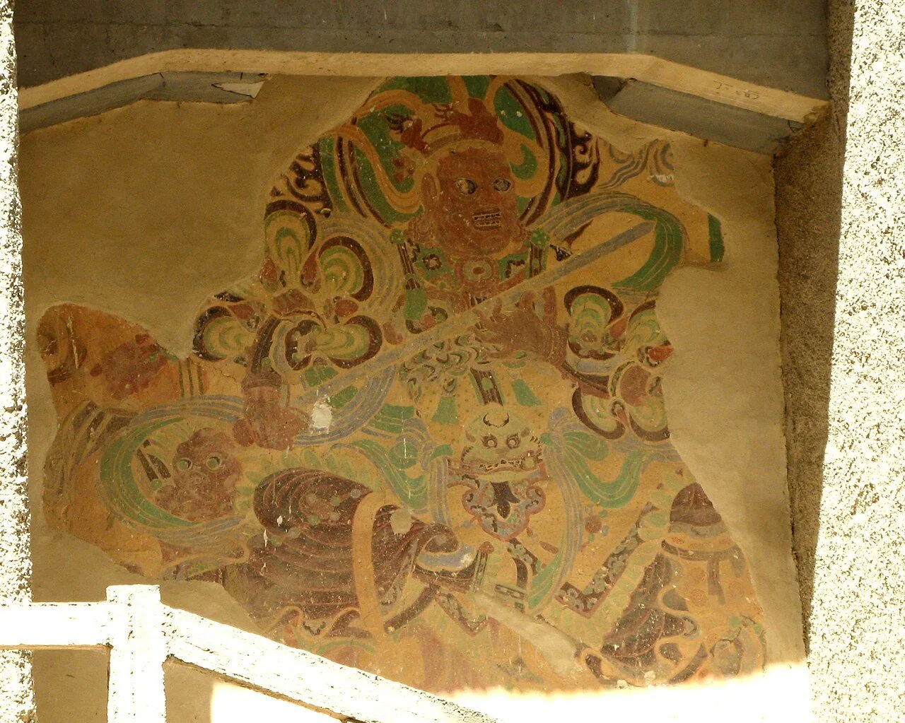 An exposed historic mural at the Mogao Caves.