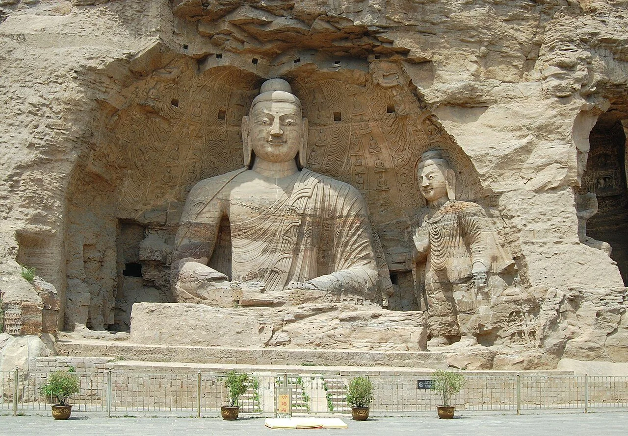 A seated Buddha carved into a cliff niche at Yungang.