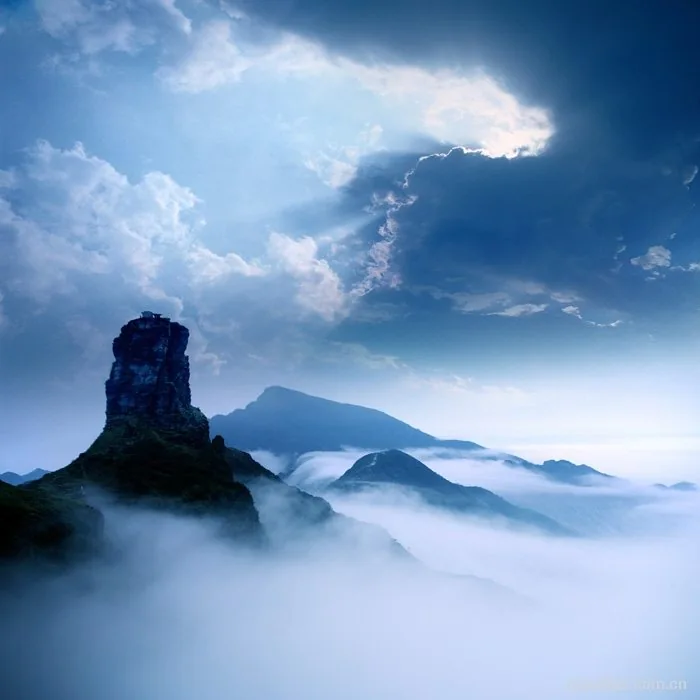 A rocky peak rises above clouds at Fanjingshan.