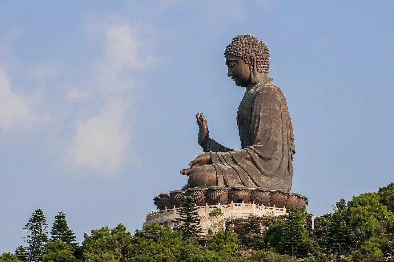 A closer side view of the Tian Tan Buddha and its raised hand.